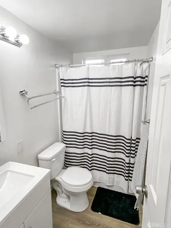 an empty room with a ceiling fan and window