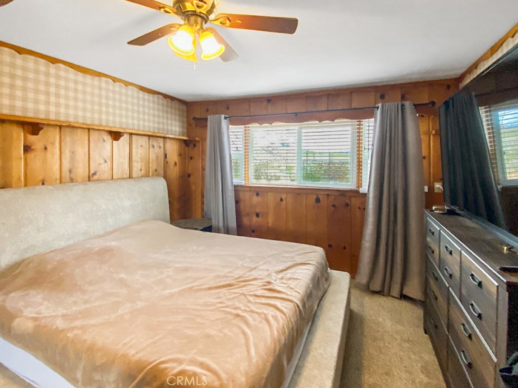 907 Ball Mountain Little Shasta Road Montague, CA 96064 - Photo 33 of 34 a bedroom with a large bed and a flat tv screen on dresser