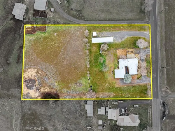 a view of a house with snow on the side of the road