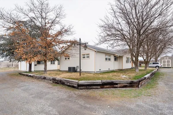 a view of house with yard and garage