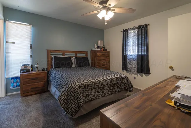 a bedroom with a bed and dresser