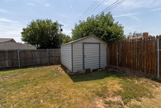 a view of a backyard with wooden fence