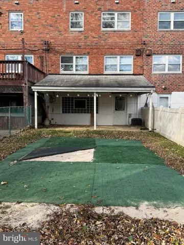a front view of a brick house with a yard