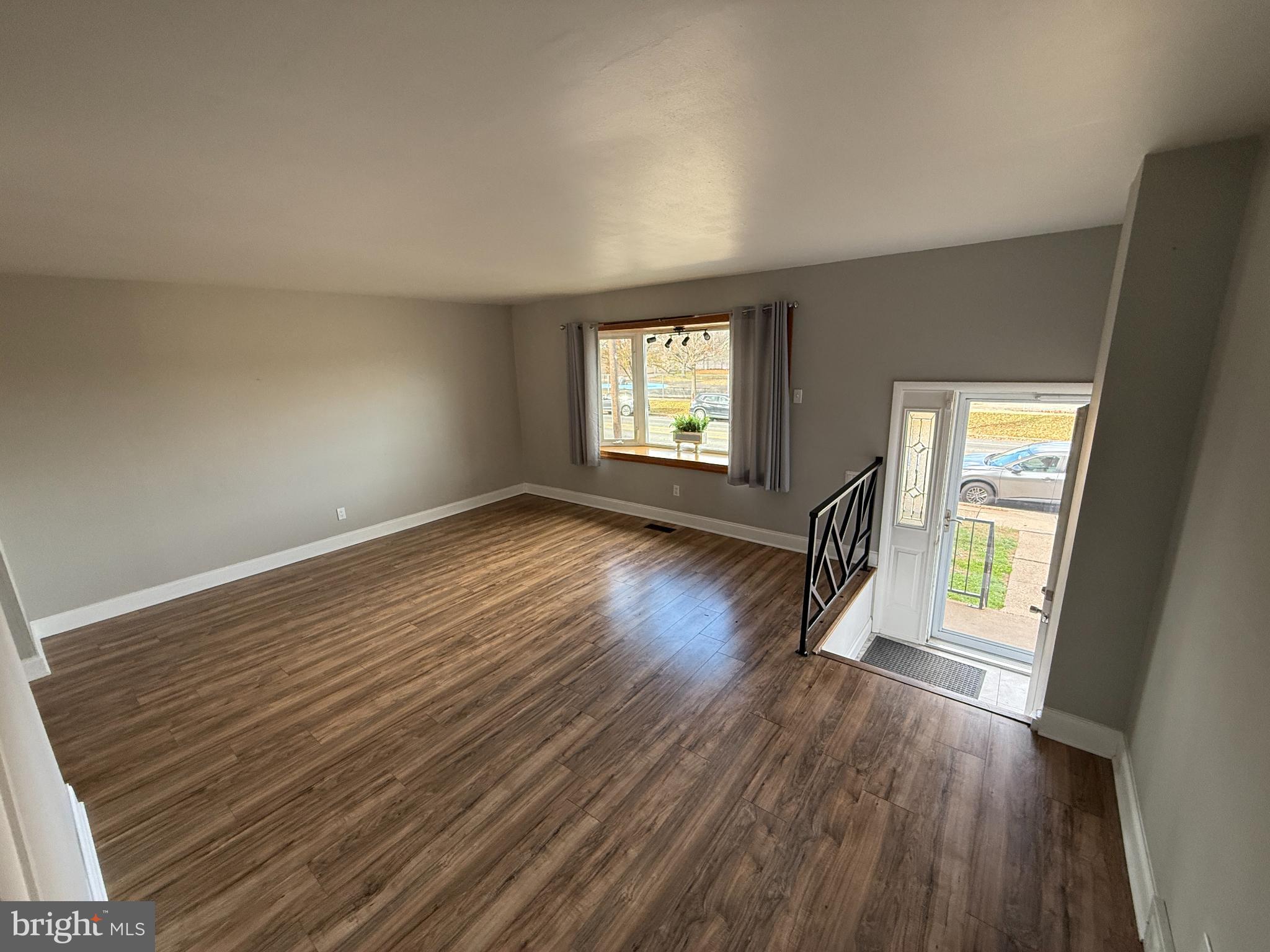 12789 Dunks Road Philadelphia, PA 19154 - Photo 4 of 23 a view of an empty room with wooden floor and a window
