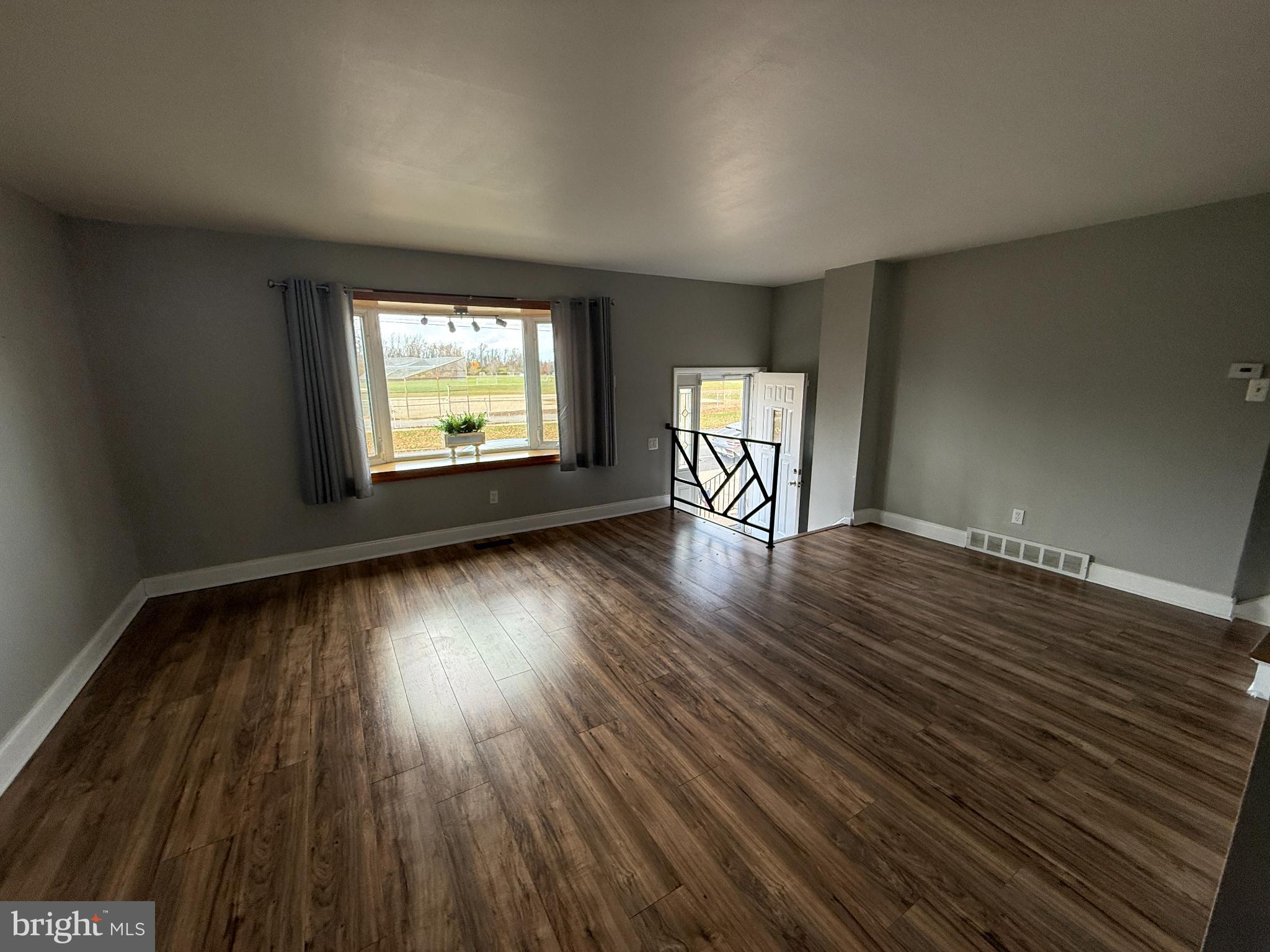 12789 Dunks Road Philadelphia, PA 19154 - Photo 6 of 23 an empty room with wooden floor and windows