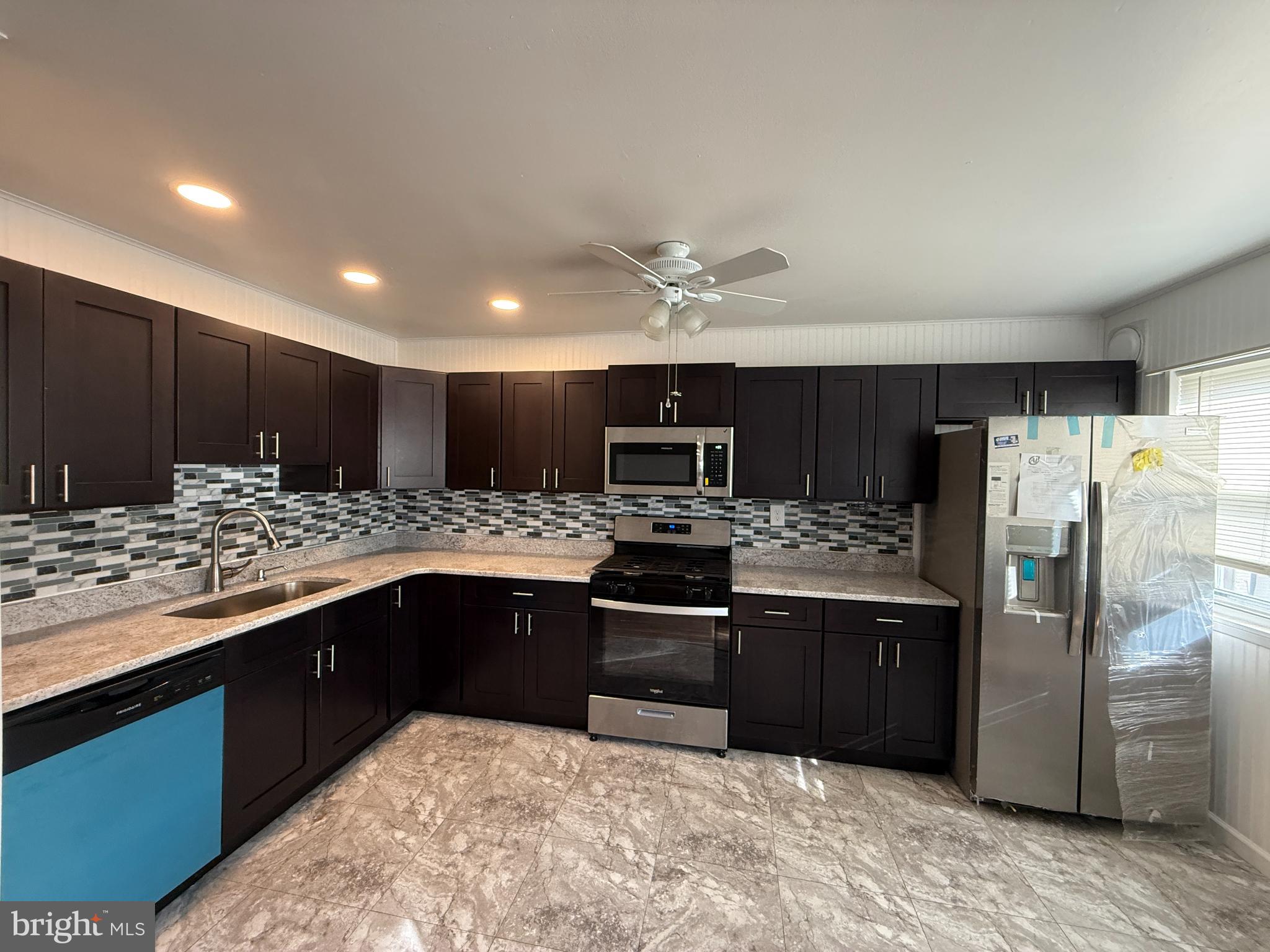 12789 Dunks Road Philadelphia, PA 19154 - Photo 7 of 23 a kitchen with stainless steel appliances granite countertop a sink stove and refrigerator