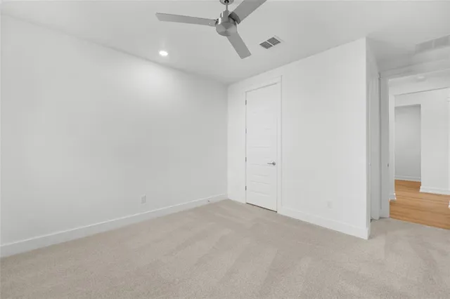 an empty room with windows and closet