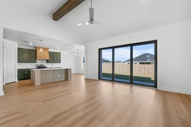 a view of a kitchen with a sink and dishwasher a refrigerator with wooden floor