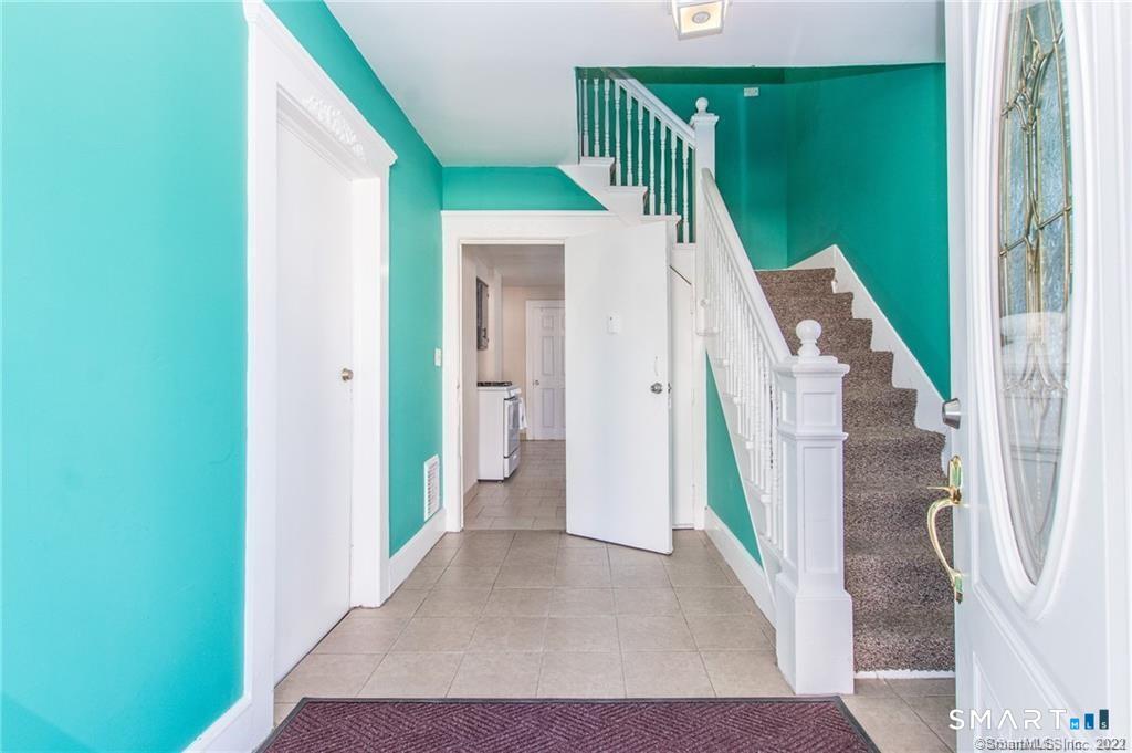 18 Lawrence Street Norwalk, CT 06854 - Photo 4 of 31 a view of a hallway with windows and stairs