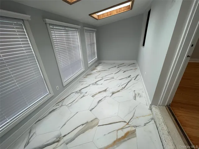 a view of a closet with wooden floor