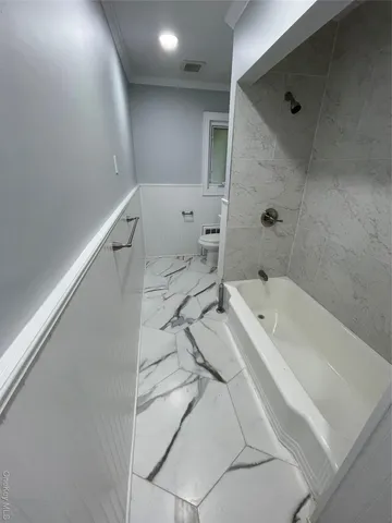 a bathroom with a bathtub and a shower