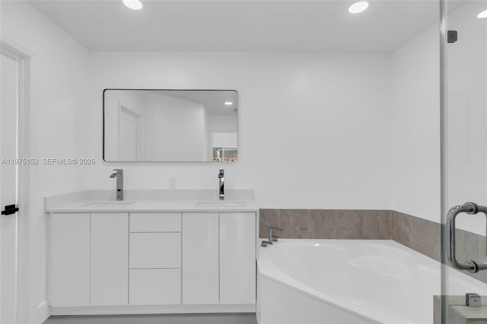 16333 Southwest 68th Terrace Miami, FL 33193 - Photo 16 of 32 a bathroom with a bathtub and a sink