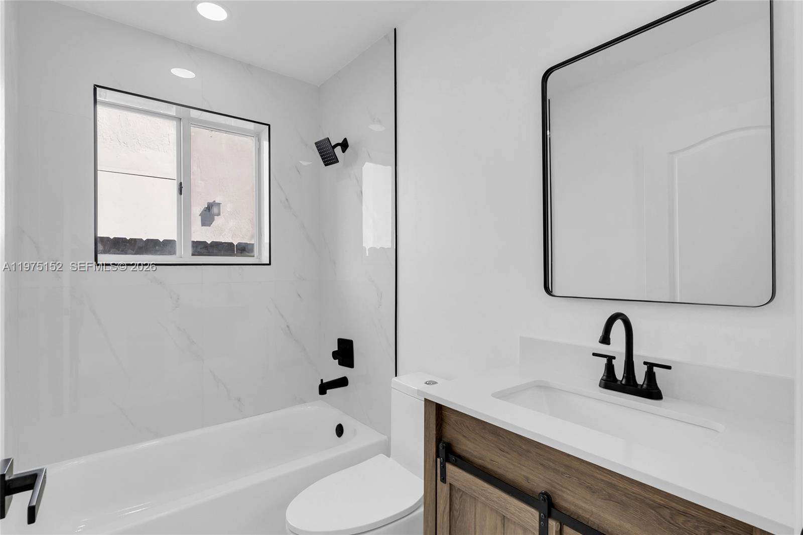 16333 Southwest 68th Terrace Miami, FL 33193 - Photo 4 of 32 a bathroom with a sink a toilet and a bathtub