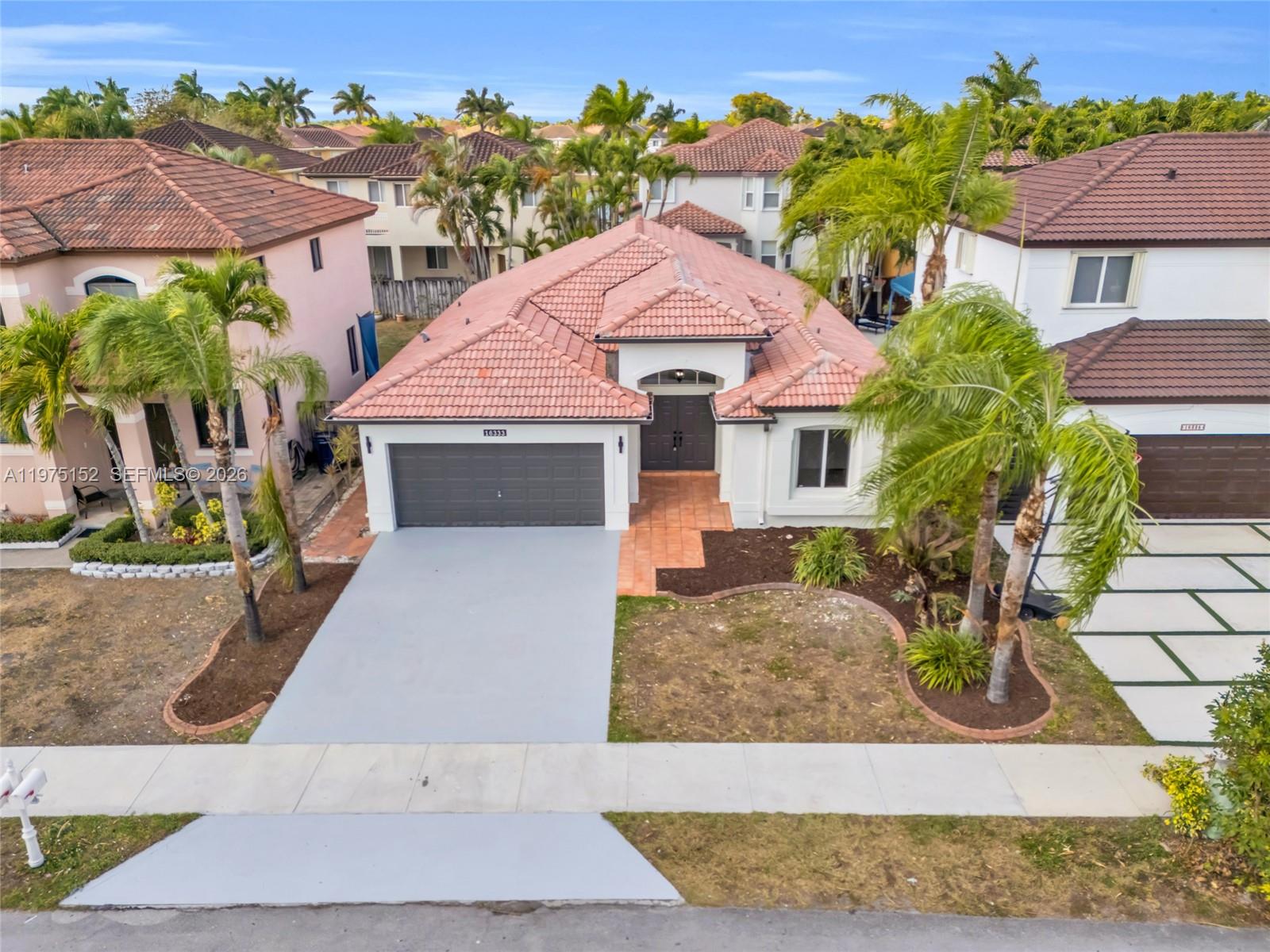16333 Southwest 68th Terrace Miami, FL 33193 - Photo 6 of 32 a front view of a house with garden