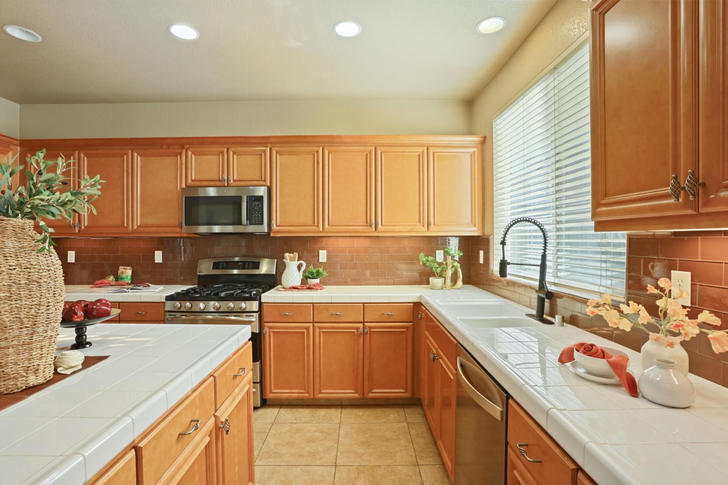 5948 Pebblestone Way Stockton, CA 95219 - Photo 16 of 46 a kitchen with a sink stove top oven and cabinets