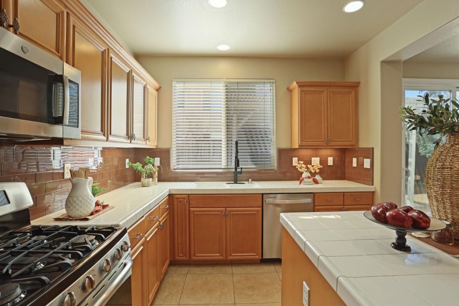 5948 Pebblestone Way Stockton, CA 95219 - Photo 18 of 46 a kitchen with a sink stove top oven and microwave