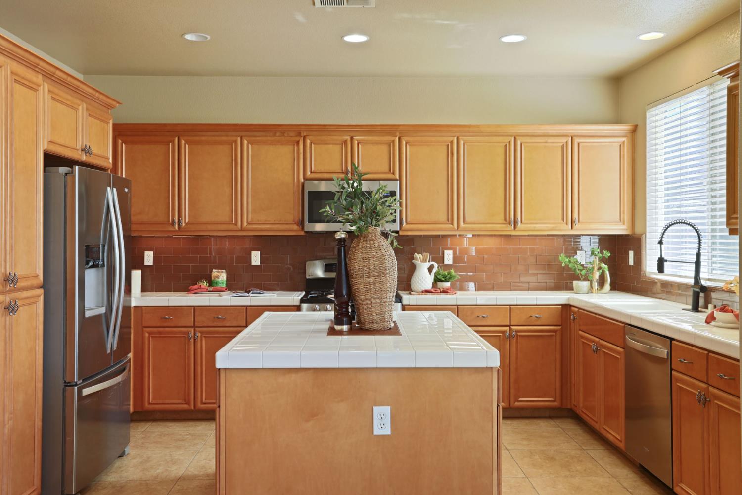 5948 Pebblestone Way Stockton, CA 95219 - Photo 20 of 46 a kitchen with a sink refrigerator and cabinets