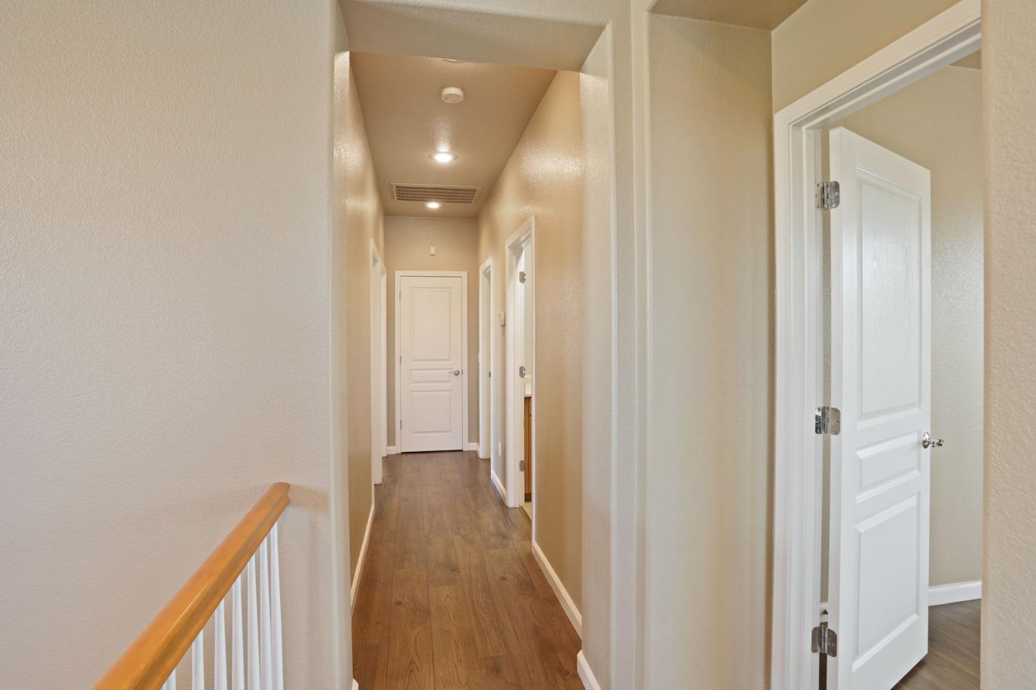 5948 Pebblestone Way Stockton, CA 95219 - Photo 22 of 46 a view of a hallway with wooden floor
