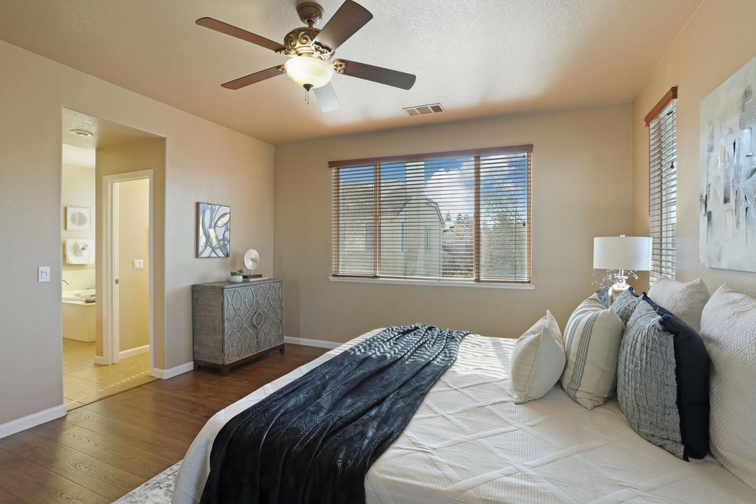 5948 Pebblestone Way Stockton, CA 95219 - Photo 24 of 46 a bedroom with a bed and a chandelier