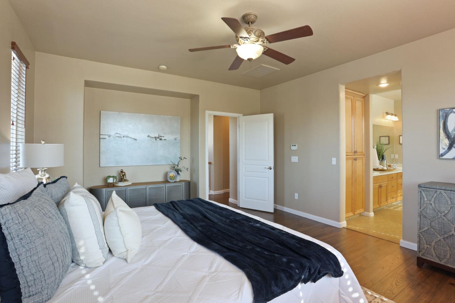 5948 Pebblestone Way Stockton, CA 95219 - Photo 25 of 46 a bedroom with a large bed and a chandelier