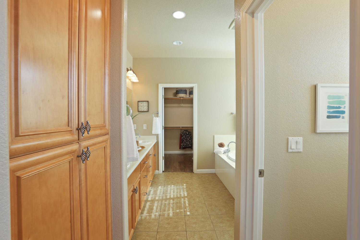 5948 Pebblestone Way Stockton, CA 95219 - Photo 26 of 46 a view of a hallway with wooden shelves