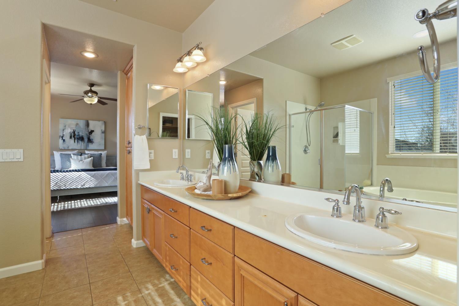 5948 Pebblestone Way Stockton, CA 95219 - Photo 27 of 46 a bathroom with a double vanity sink and a mirror