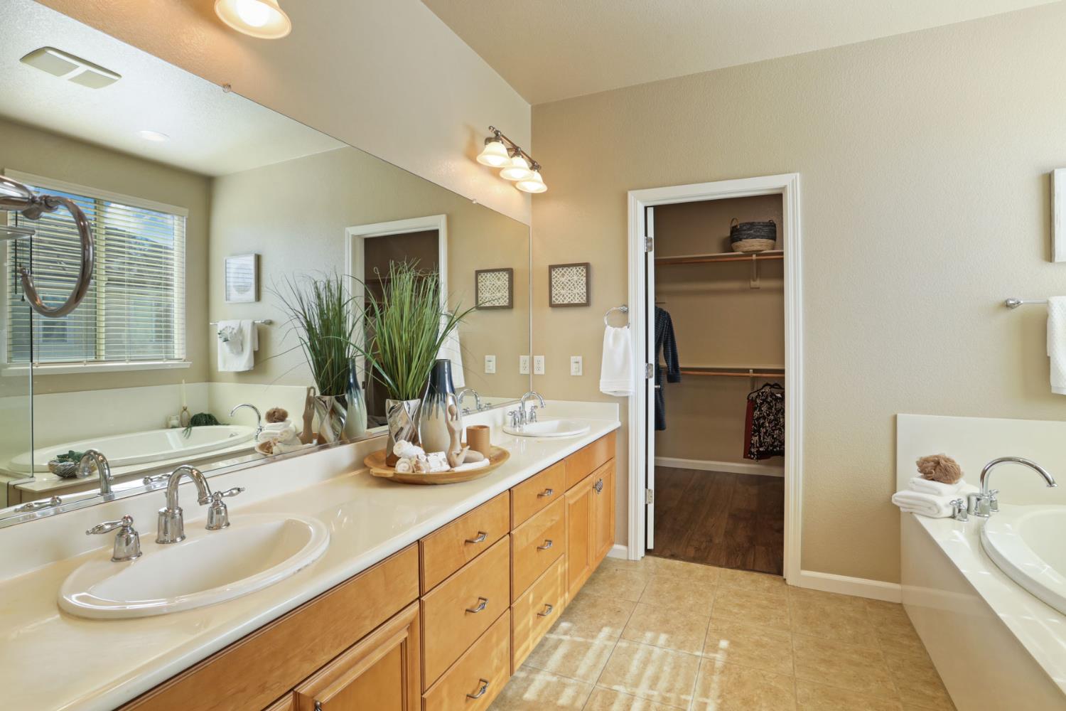 5948 Pebblestone Way Stockton, CA 95219 - Photo 30 of 46 a spacious bathroom with a double vanity sink mirror and bathtub