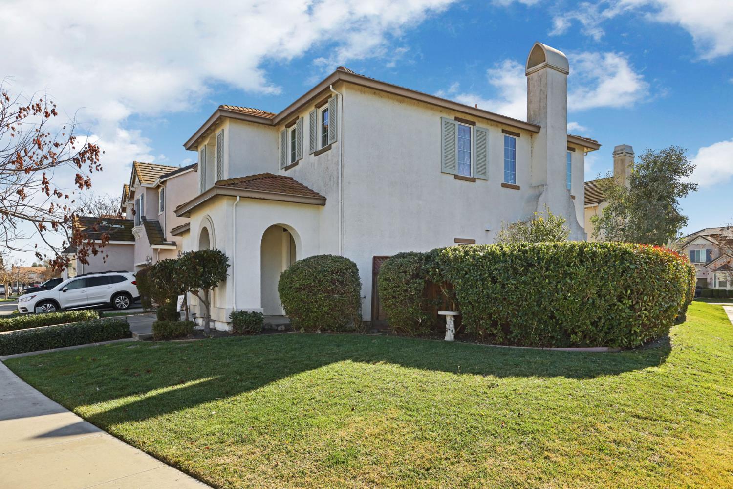 5948 Pebblestone Way Stockton, CA 95219 - Photo 3 of 46 a front view of a house with garden