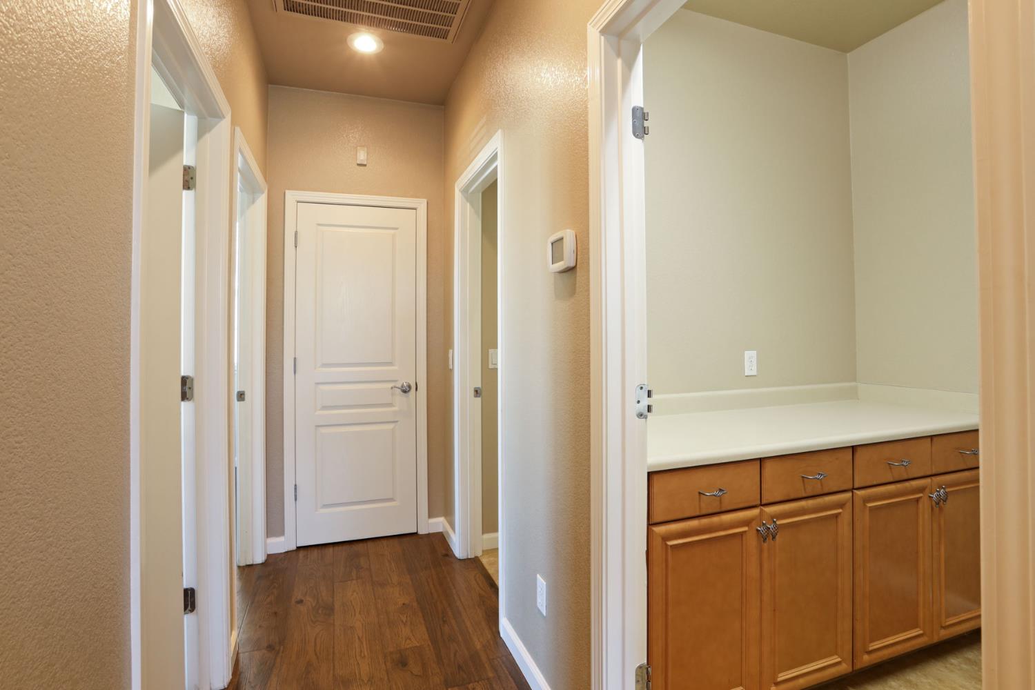 5948 Pebblestone Way Stockton, CA 95219 - Photo 32 of 46 a view of a hallway with wooden floor