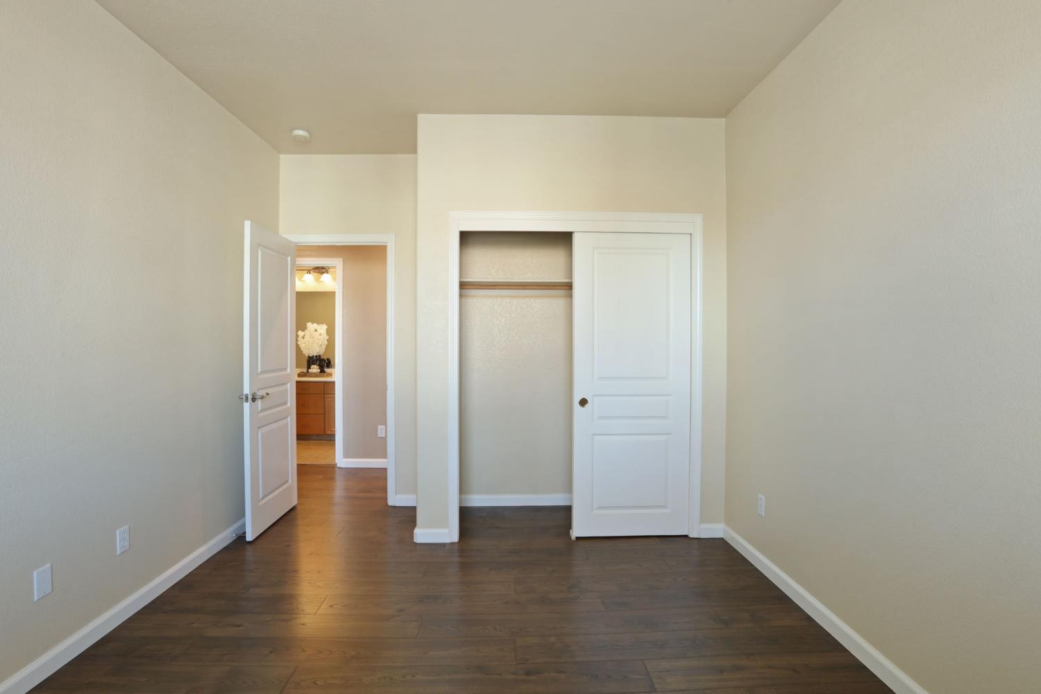5948 Pebblestone Way Stockton, CA 95219 - Photo 35 of 46 an empty room with wooden floor & closet area
