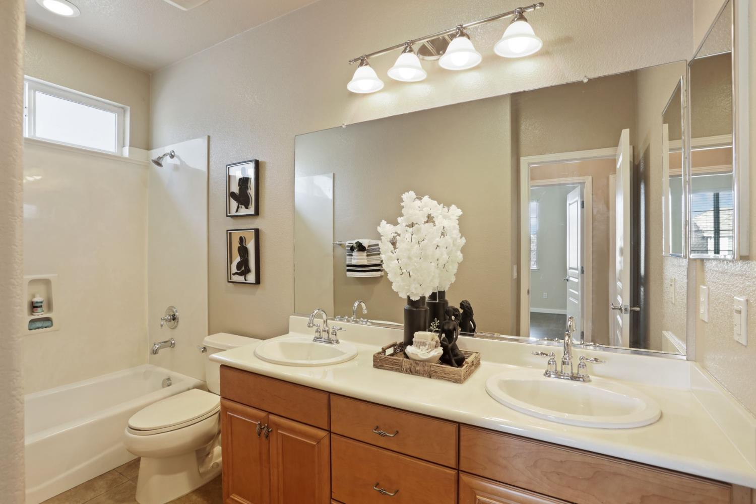 5948 Pebblestone Way Stockton, CA 95219 - Photo 36 of 46 a bathroom with a double vanity sink mirror and toilet