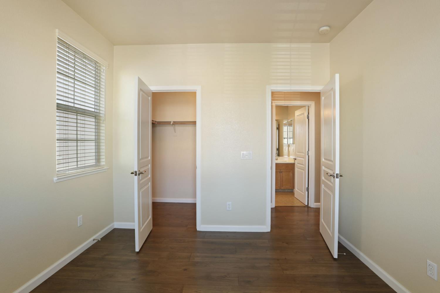 5948 Pebblestone Way Stockton, CA 95219 - Photo 39 of 46 an empty room with wooden floor and windows