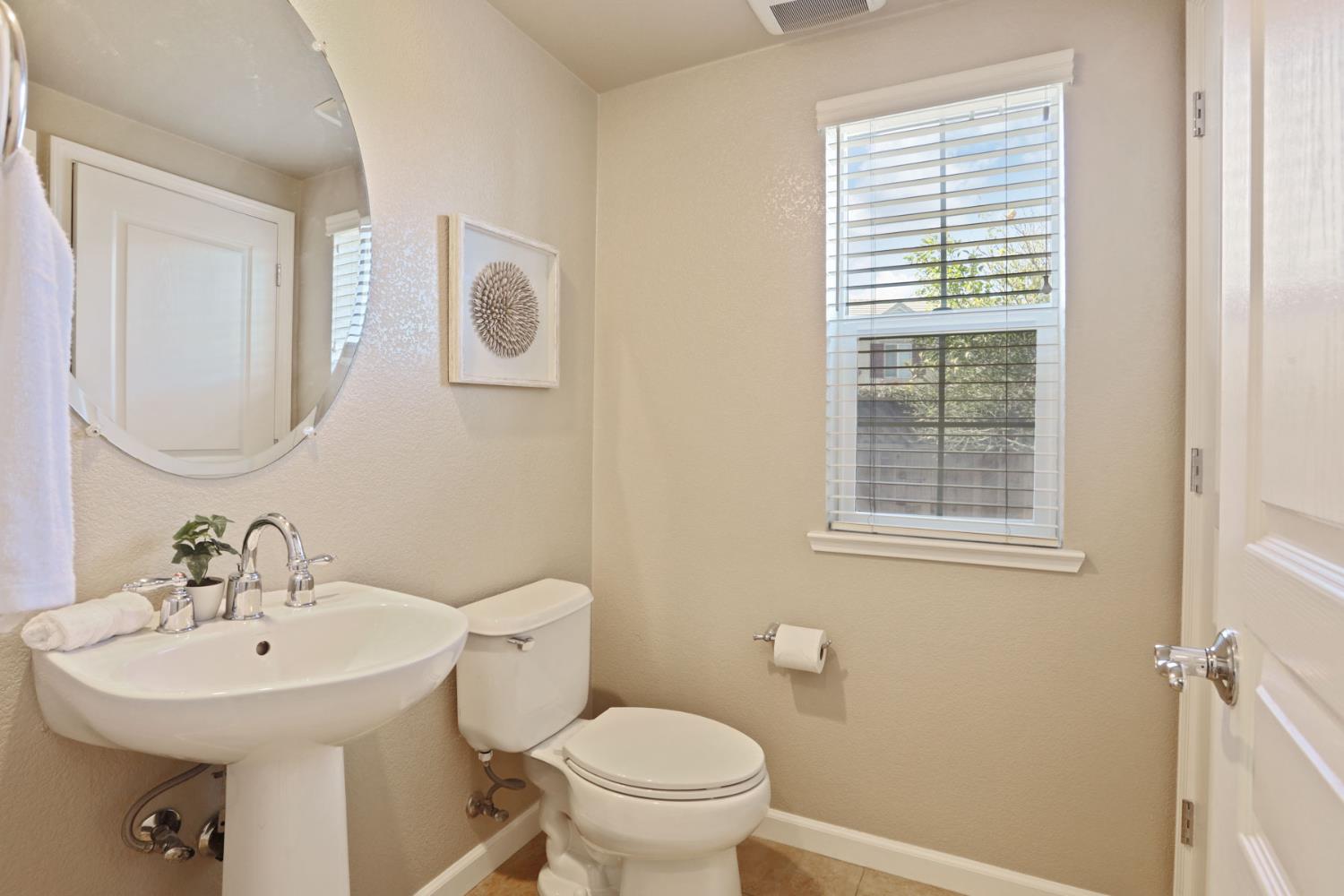 5948 Pebblestone Way Stockton, CA 95219 - Photo 9 of 46 a bathroom with a sink a toilet and a mirror