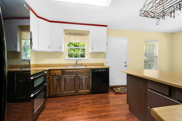 a kitchen with stainless steel appliances granite countertop a sink stove and cabinets