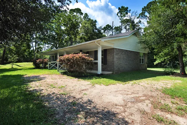 a backyard of a house with plants and trees