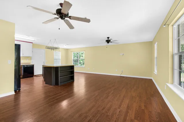 a view of kitchen and hall with wooden floor