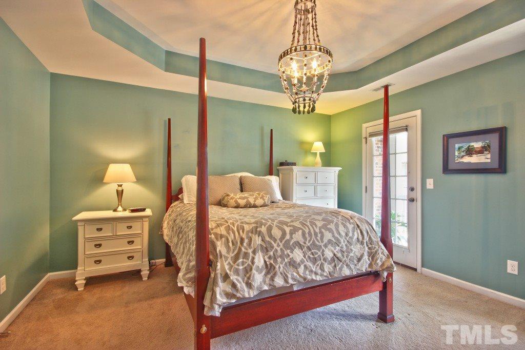 511 Dragby Lane Raleigh, NC 27603 - Photo 14 of 24 a bedroom with a bed chandelier and a window