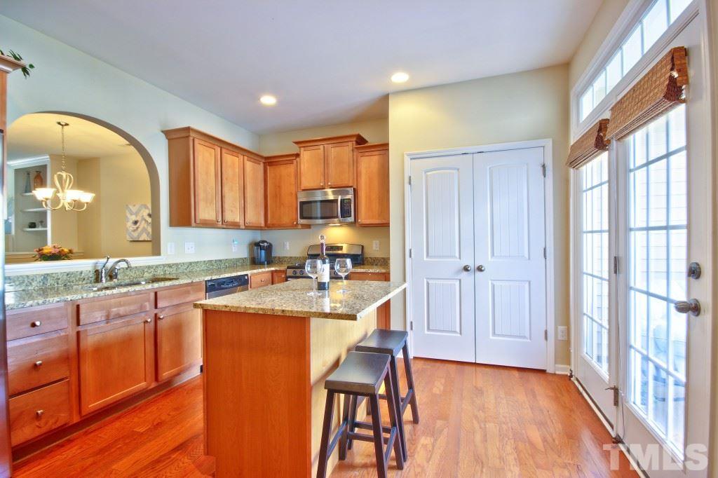 511 Dragby Lane Raleigh, NC 27603 - Photo 8 of 24 a kitchen with a sink a stove cabinets and wooden floor
