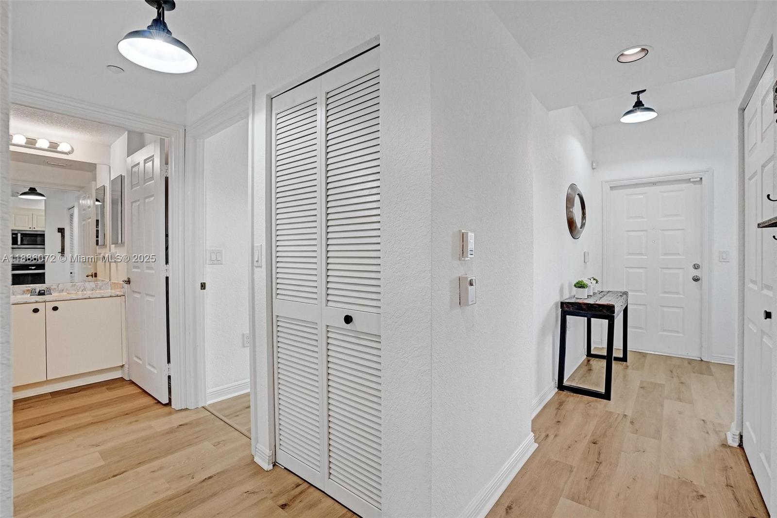 7635 Southampton Terrace, Unit 307 Tamarac, FL 33321 - Photo 16 of 43 a view of a hallway with wooden floor and staircase