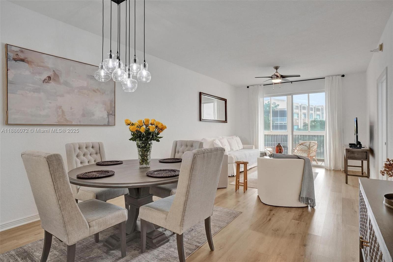 7635 Southampton Terrace, Unit 307 Tamarac, FL 33321 - Photo 17 of 43 a dining room with furniture a chandelier and wooden floor