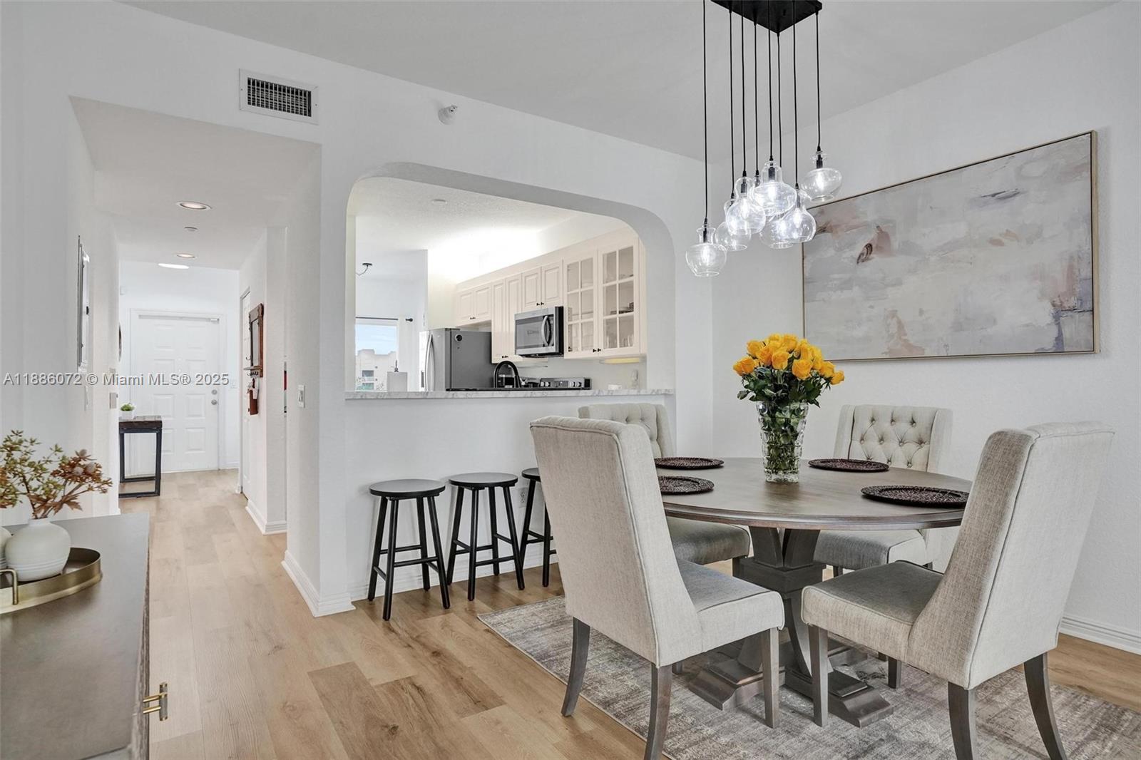 7635 Southampton Terrace, Unit 307 Tamarac, FL 33321 - Photo 18 of 43 a view of a dining room with furniture and chandelier