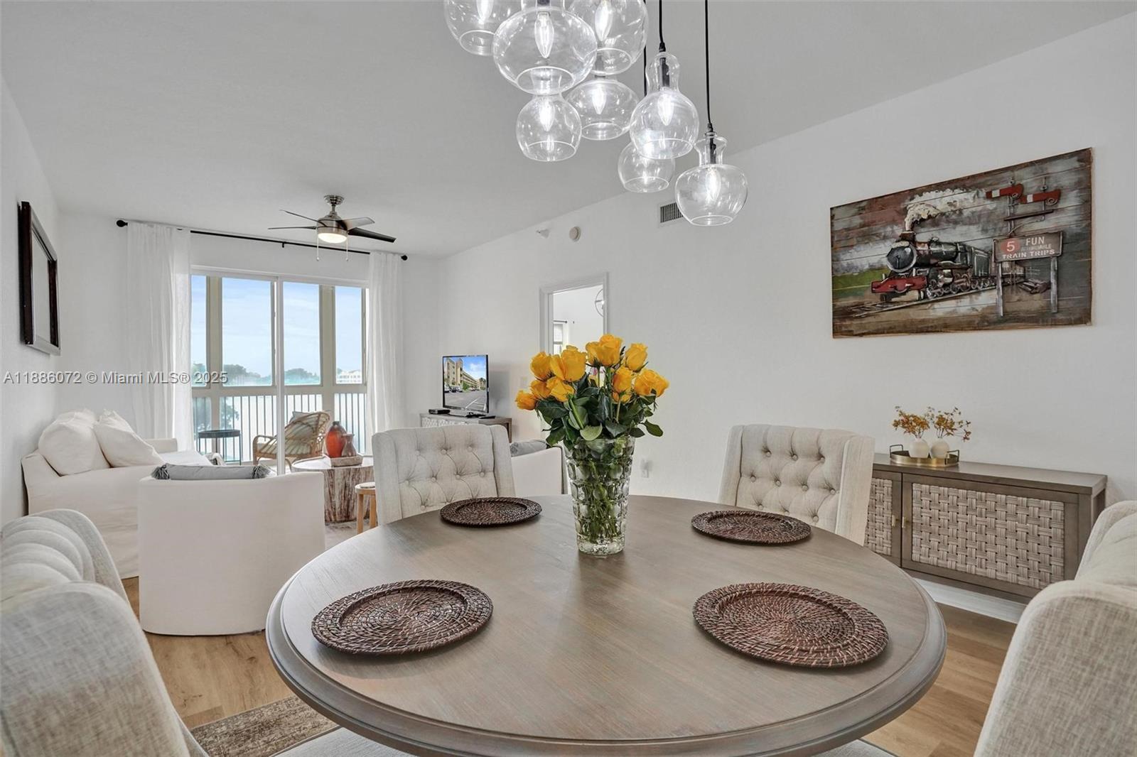 7635 Southampton Terrace, Unit 307 Tamarac, FL 33321 - Photo 20 of 43 a living room with furniture a chandelier and a table