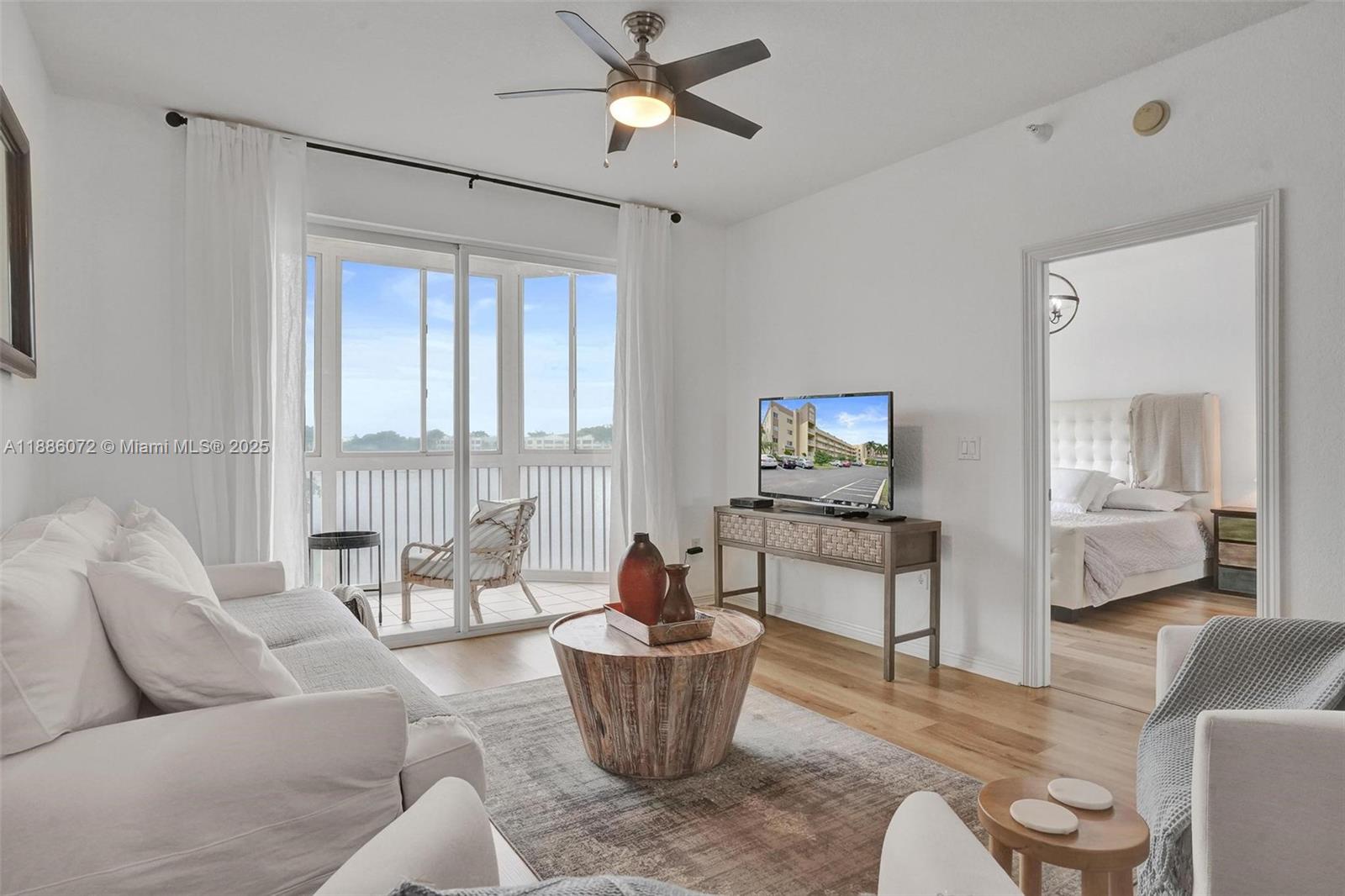 7635 Southampton Terrace, Unit 307 Tamarac, FL 33321 - Photo 22 of 43 a living room with furniture and a large window