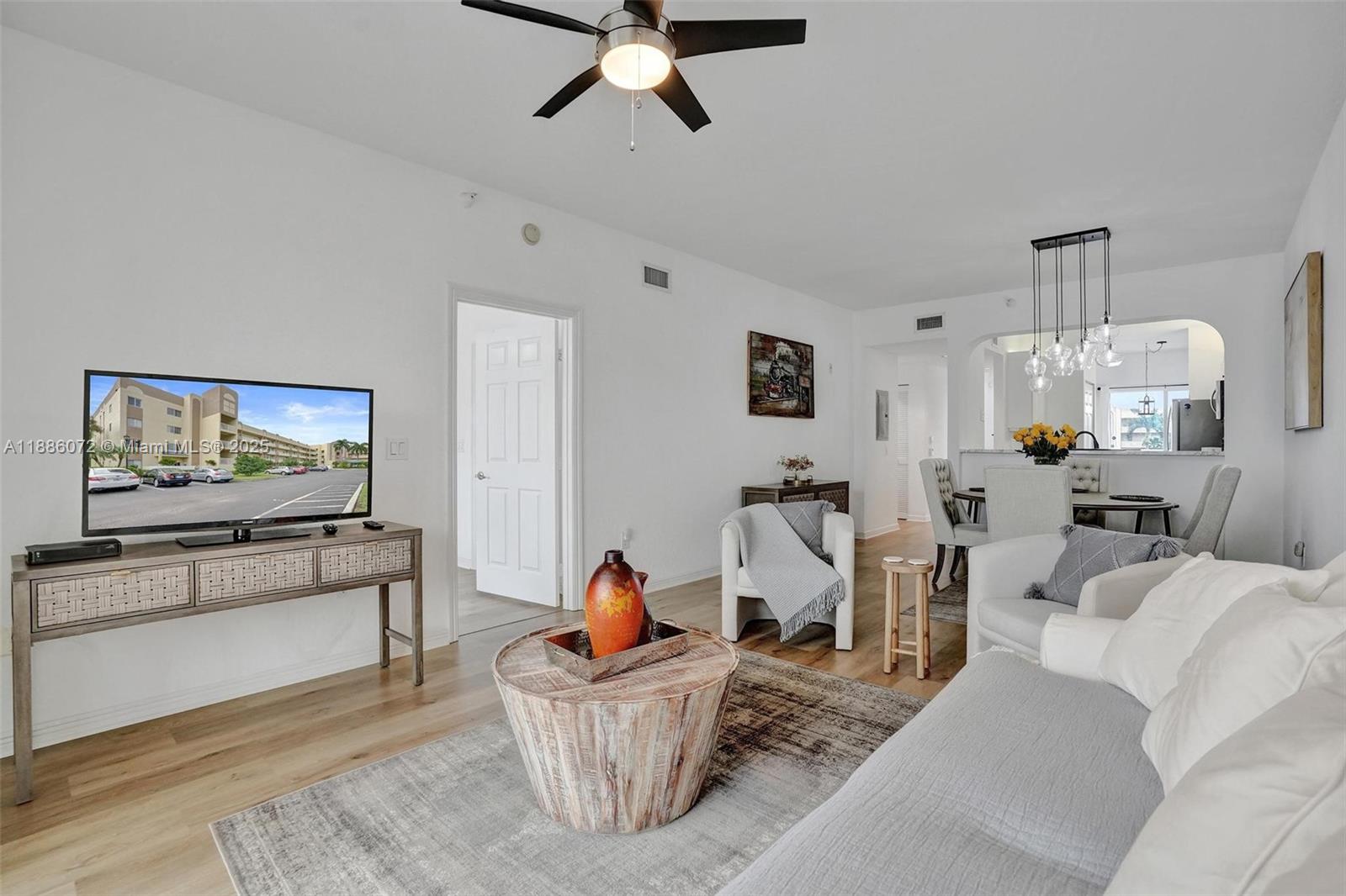 7635 Southampton Terrace, Unit 307 Tamarac, FL 33321 - Photo 24 of 43 a living room with furniture and a flat screen tv