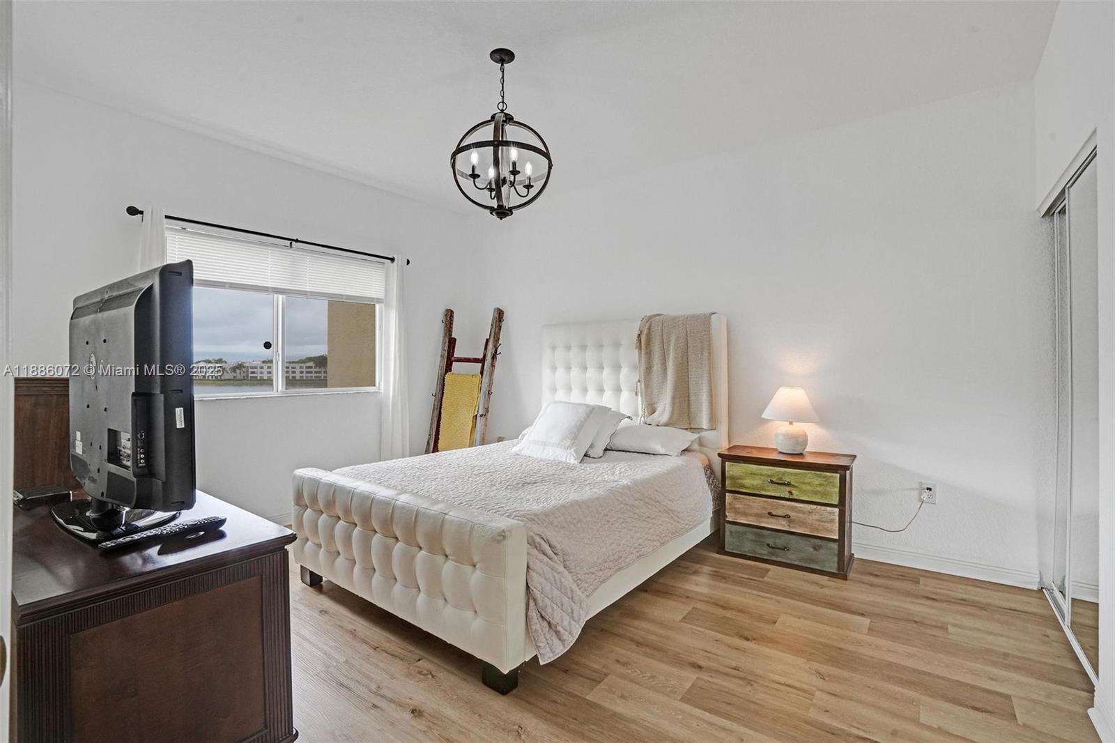 7635 Southampton Terrace, Unit 307 Tamarac, FL 33321 - Photo 25 of 43 a bedroom with a bed and a table in it