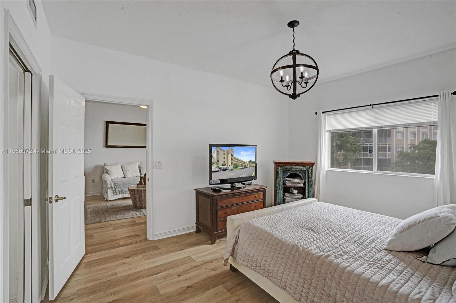 7635 Southampton Terrace, Unit 307 Tamarac, FL 33321 - Photo 26 of 43 a bedroom with a bed and a window