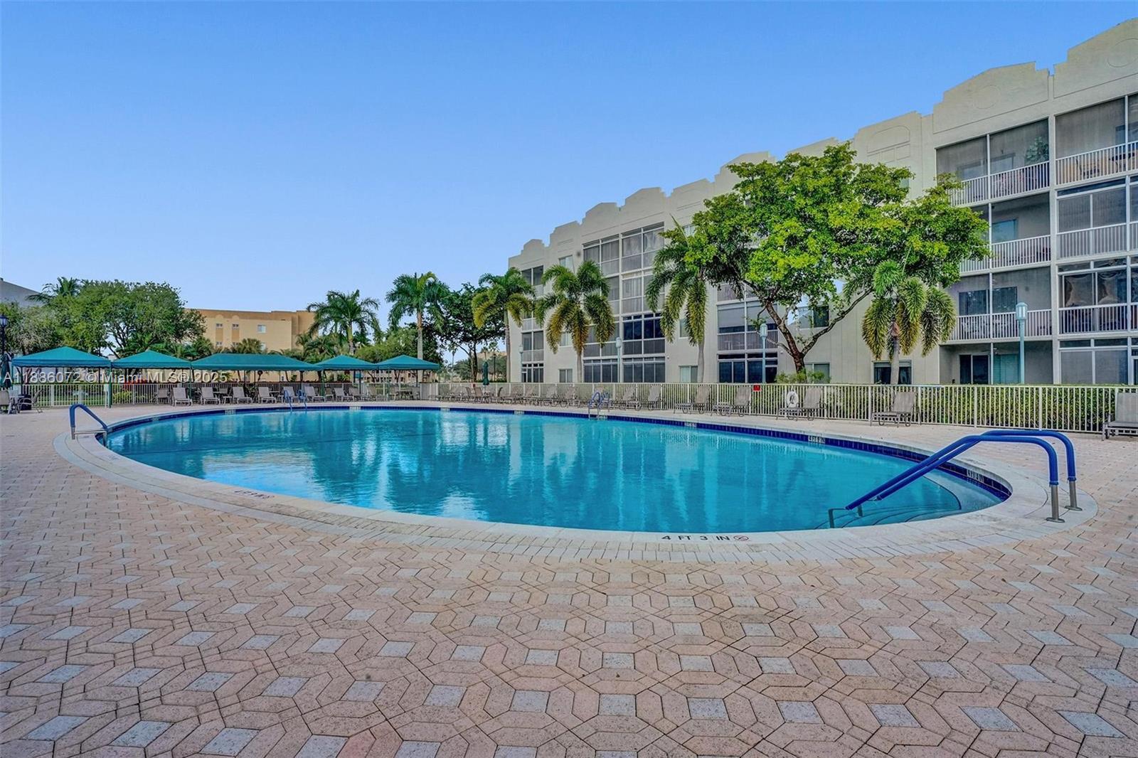 7635 Southampton Terrace, Unit 307 Tamarac, FL 33321 - Photo 42 of 43 a swimming pool with outdoor seating and yard