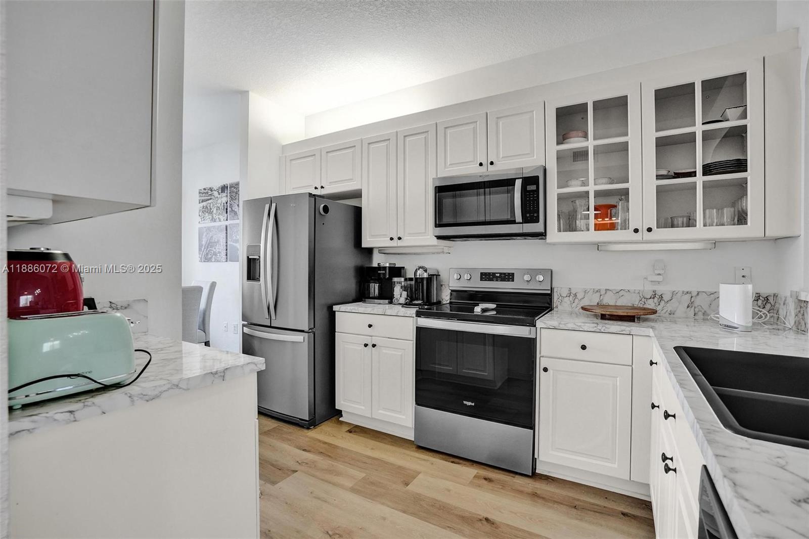 7635 Southampton Terrace, Unit 307 Tamarac, FL 33321 - Photo 7 of 43 a kitchen with cabinets stainless steel appliances and a sink
