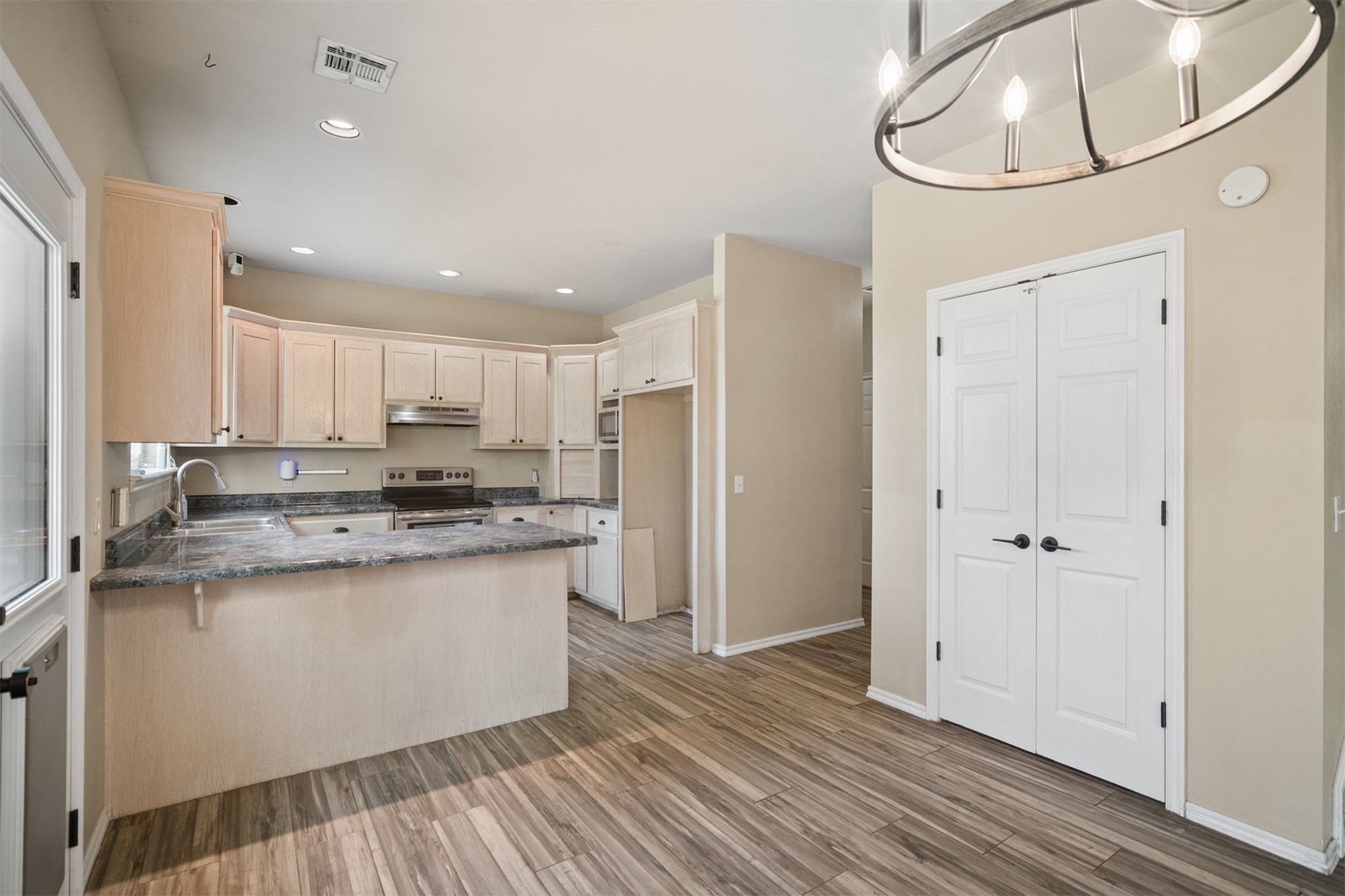 175 Alt 75 Mounds, OK 74047 - Photo 21 of 41 Modern kitchen featuring light wood cabinetry, stainless steel appliances, and granite countertops with a centered island