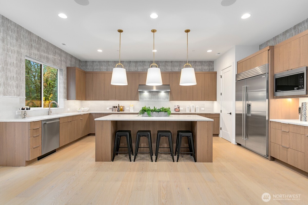 1455 153rd Place Southeast Bellevue, WA 98007 - Photo 11 of 39 a large kitchen with a table and chairs in it